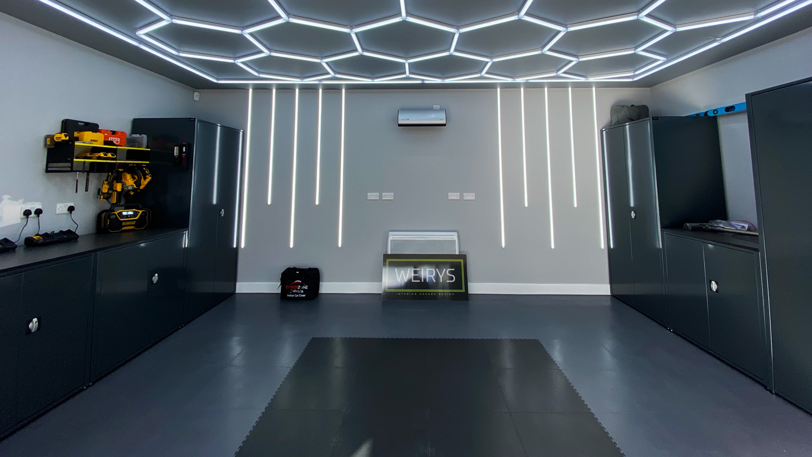 Weirys garage with interlocking flooring and lighting